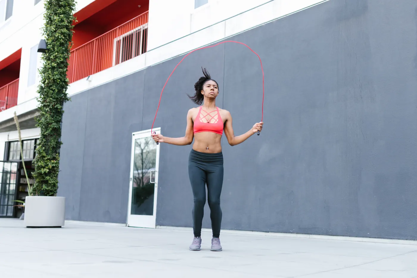 Woman skipping rope outdoors in the sunshine